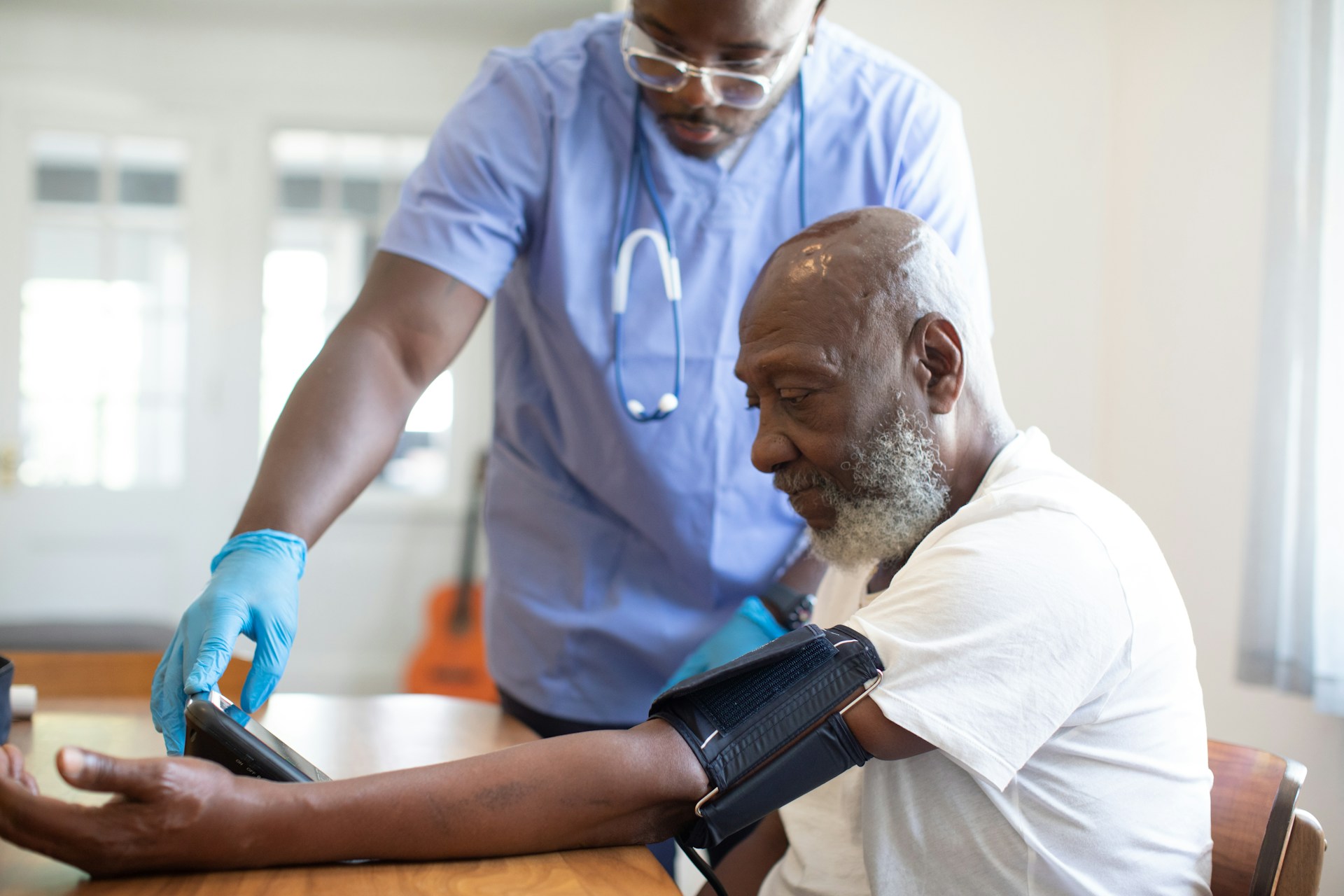 nurse checking patient's blood pressure